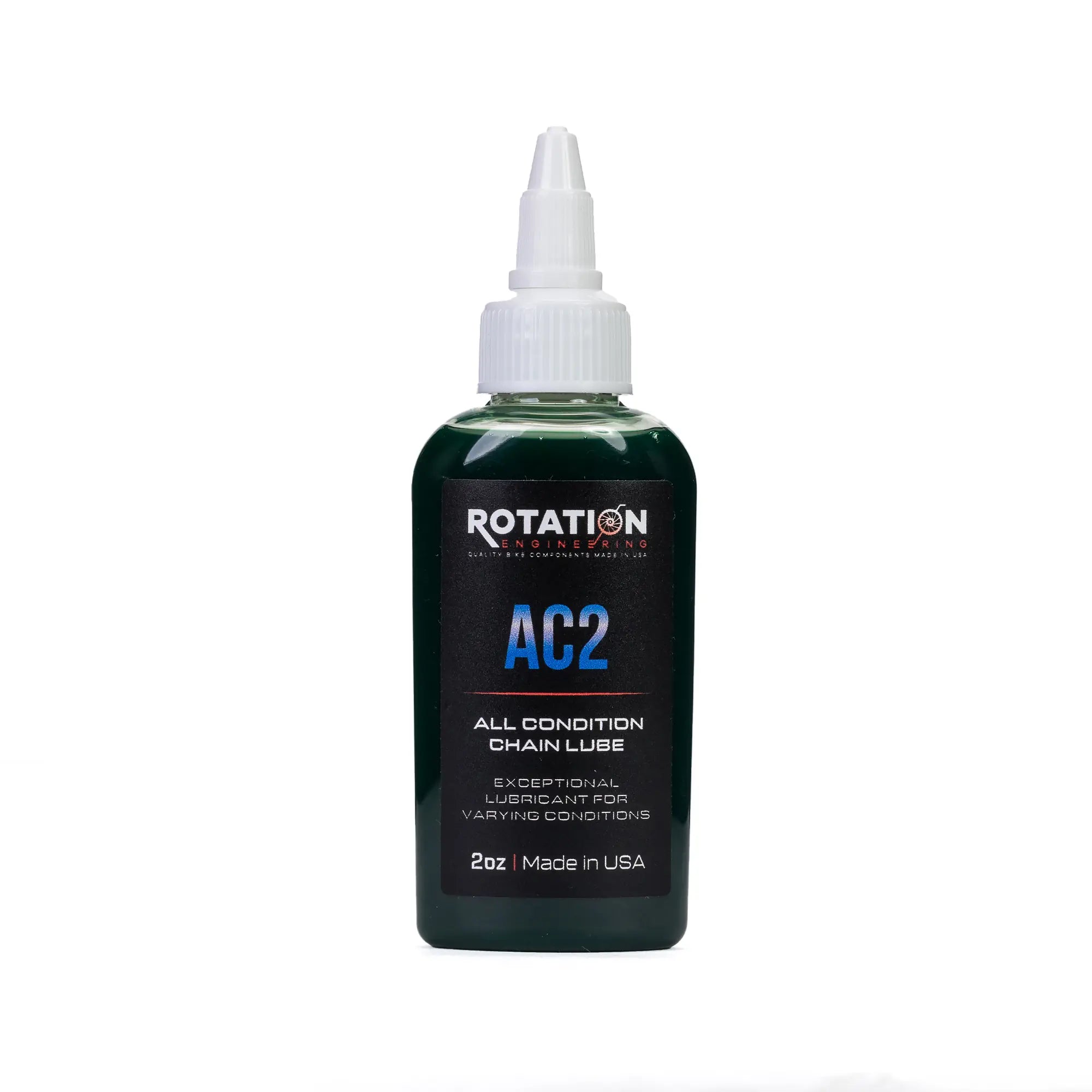 Bottle of Rotation AC2 All Condition Chain Lube with a white nozzle, dark green body, and a label noting "Made in USA" for versatile use.